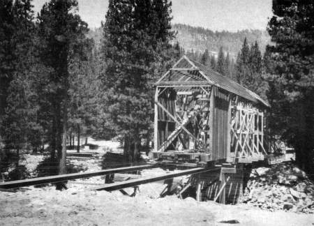 Covered bridge. Easing the Wawona covered bridge back into place.